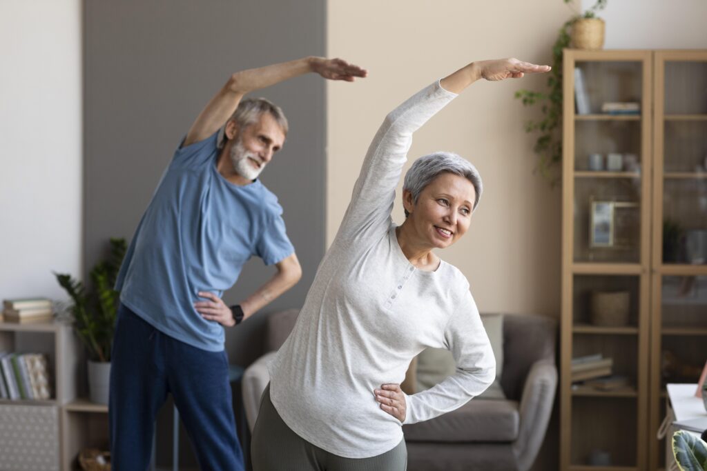 Senior exercising with resistance bands for health in help for elderly in home.